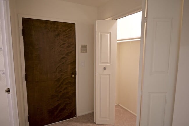Entry door to the unit, with coat closet - 1250 Park Ave W Unit 408