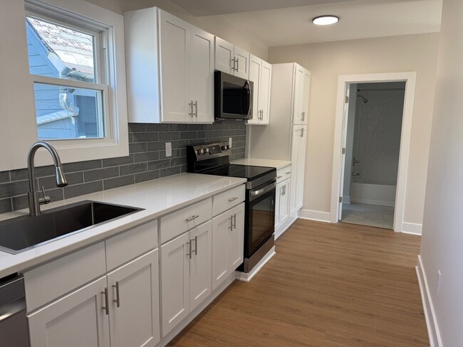 full kitchen with soft close cabinetry and quartz counters - 202 Vermont St Unit upper