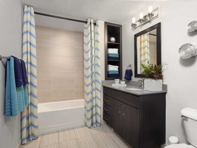 Spacious bathrooms with built-in shelves and framed mirrors - Studio LoHi Apartments