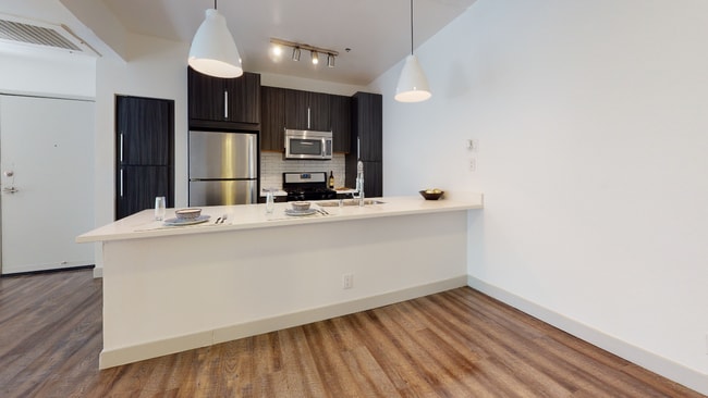 Reimagined kitchen with granite countertops and stainless steel appliances.