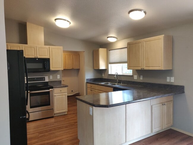Photo - Charming 4-Bedroom Home on 1/2 Acre with a Fenced Backyard, Fully Insulated Double-Car Garage, in...