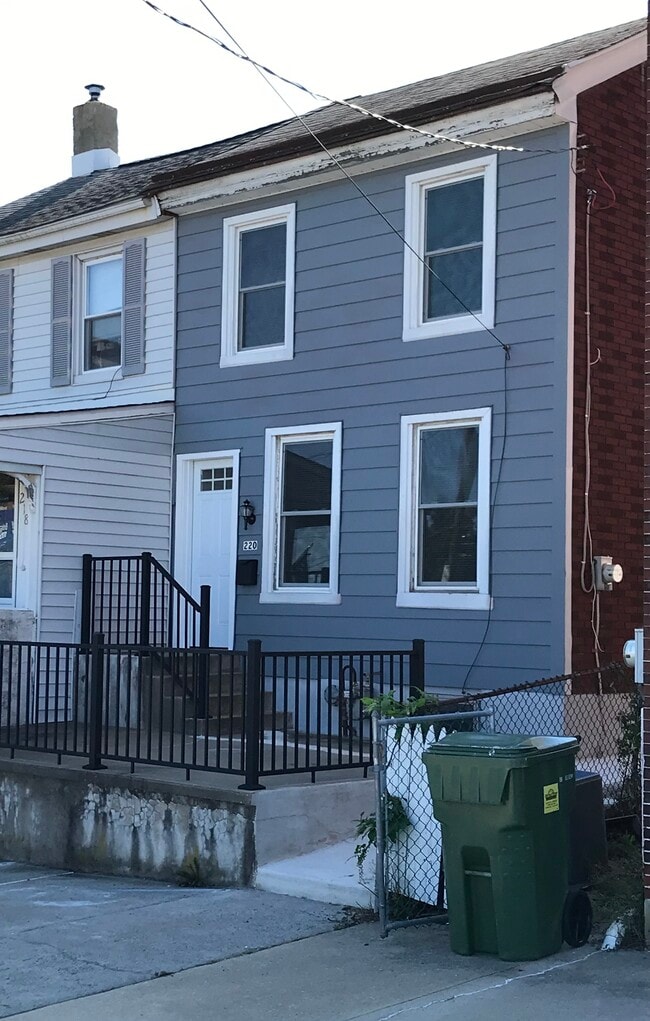 Front of home with large patio fenced in with aluminum railings - 220 Prospect Ave Townhome