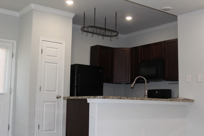 Kitchen with black cabinets - 16922 Showdown Path