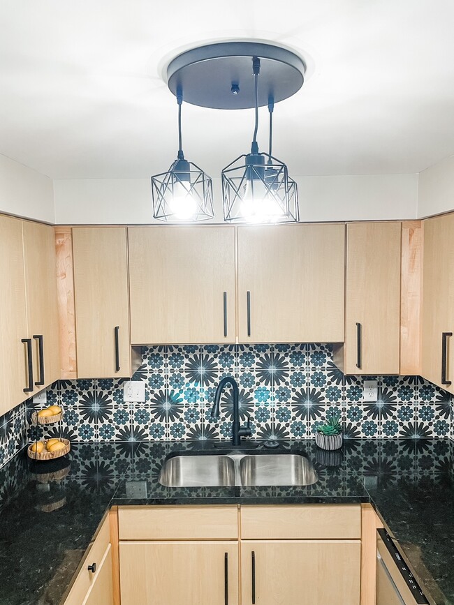 Updated kitchens with designer finishes - 5801 Sunshine Dr Apartments