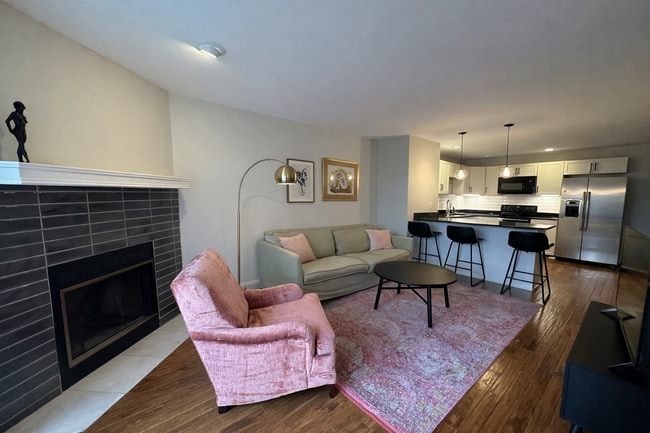 Open living space with a classic wood-burning fireplace. - 524 Superior St
