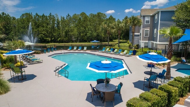 Dive into luxury from above! Our vibrant pool, sun loungers, and the tranquil lake fountain are a sight to behold.