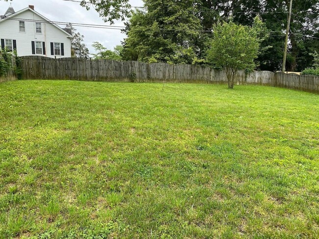 Photo - Spacious 5BR/2BA Single Family | Fresh Paint + New Carpet | New Kitchen Floor | Huge Yard + Deck