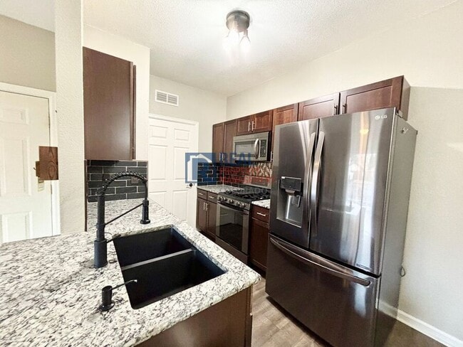 Building Photo - 5633 E Atlantic Pl Unit 2B