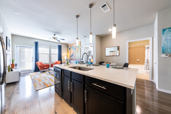 Kitchen, living, and dining area with hard surface flooring - Avalon Wolf Ranch
