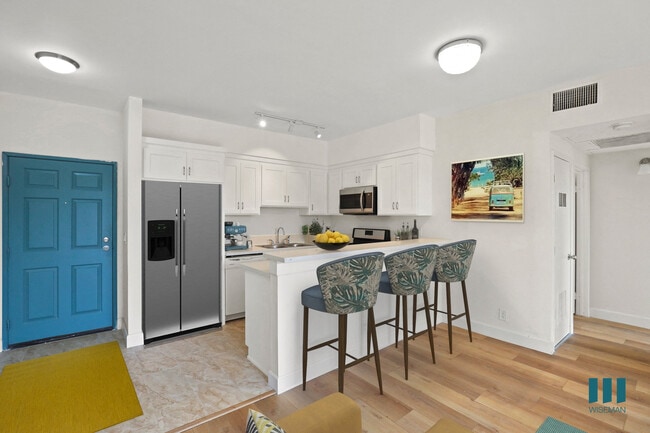 Front Entrance and Open-Concept Kitchen with Countertop Bar