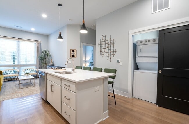 Quarry Trails Model washer/dryer, island kitchen and living room