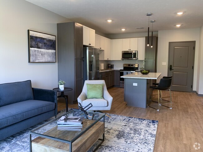 Open-concept living spaces combine modern kitchens with cozy lounge areas, creating the perfect home for relaxation and connection. - Haven at Uptown Rental