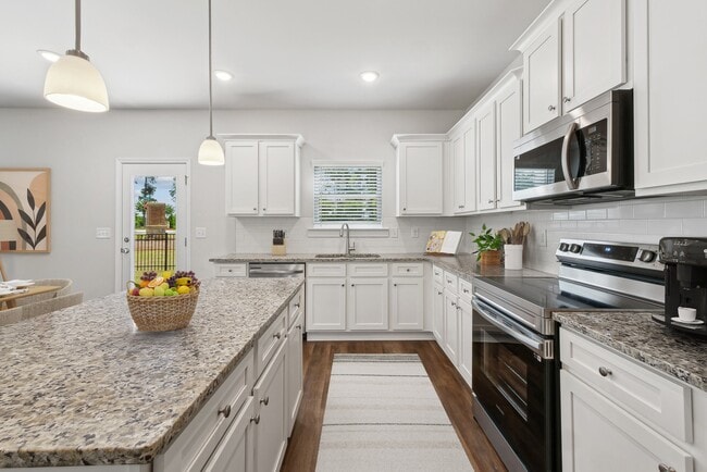 A view of the spacious kitchen and stainless steel appliances