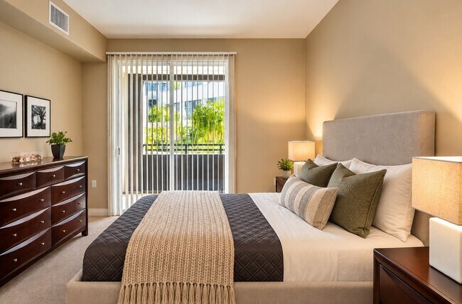 Indulge in the serene atmosphere of The Pointe, where modern design meets comfort. This elegant bedroom invites relaxation with its cozy furnishings and access to private outdoor space. Don’t miss your chance to call this space home!