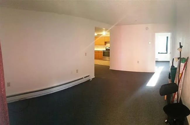 Living room with view into kitchen and bedroom
