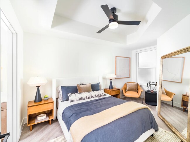 Retreat to a light-filled bedroom at Modera St. Paul, where clean design and inviting details create a calming escape in the center of Dallas.