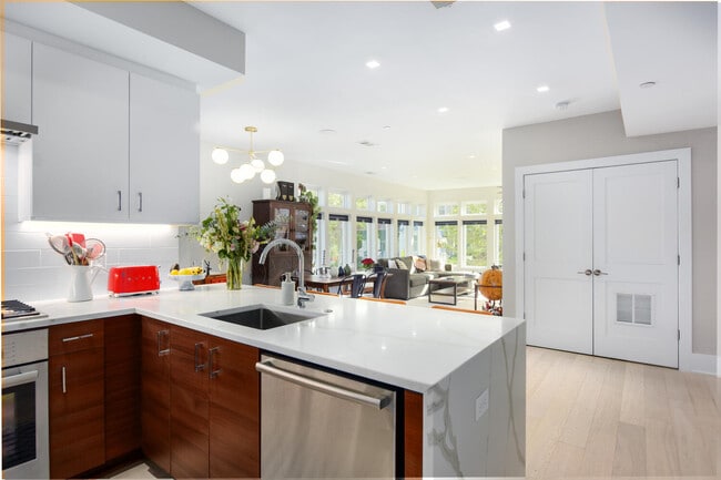Open concept kitchen with waterfall quartz countertops. - 1001 Monroe St NW Unit #3