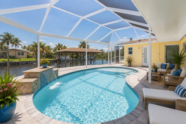 Photo - Live the ultimate Space Coast waterfront lifestyle at this stunning beachside canal home in Satel...