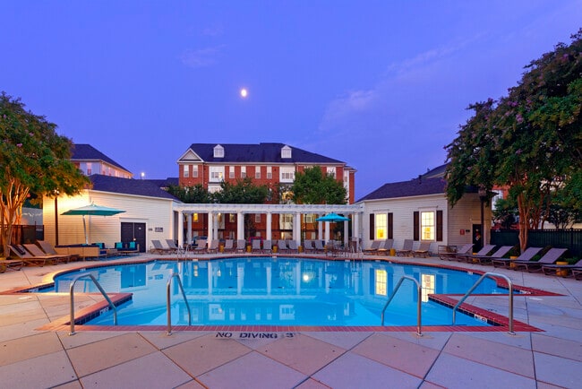 Courtyard with swimming pool, sundeck with lounge seating - Avalon at Arlington Square Apartments