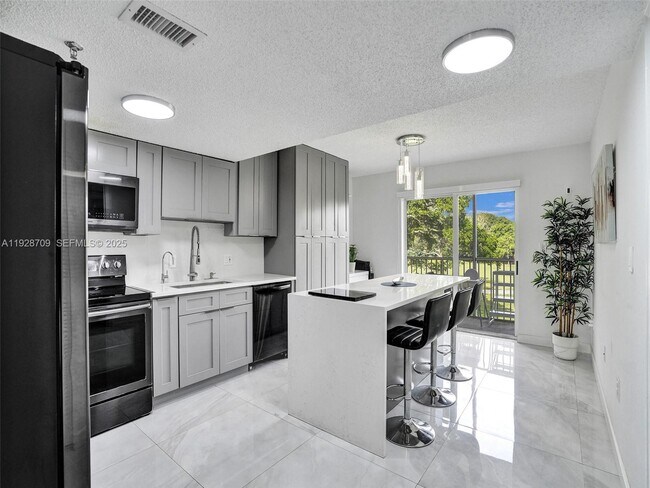 Building Photo - 9470 Tangerine Pl Unit 207