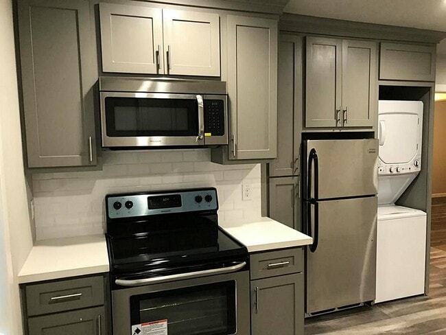 Kitchen with stainless steel appliances (1 year old), quartz countertops, and subway tile backsplash - 5005 Tierwester st
