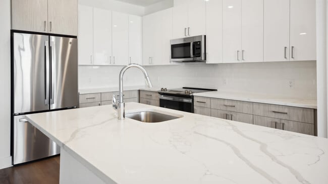 Kitchen with Stainless Steel Appliances and White Granite Countertops