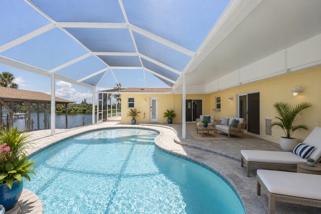 Photo - Live the ultimate Space Coast waterfront lifestyle at this stunning beachside canal home in Satel...