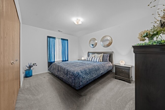 Cozy bedroom with natural light at Westwood Village Apartments in Westland, MI - Westwood Village Apartments