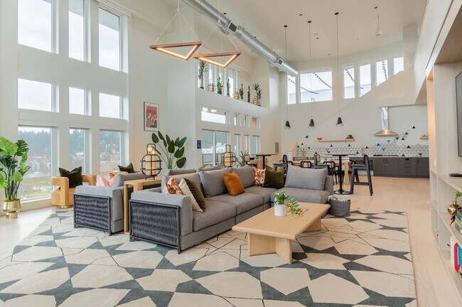 Relax in the Sky Lounge with large HDTV, kitchen and workspace