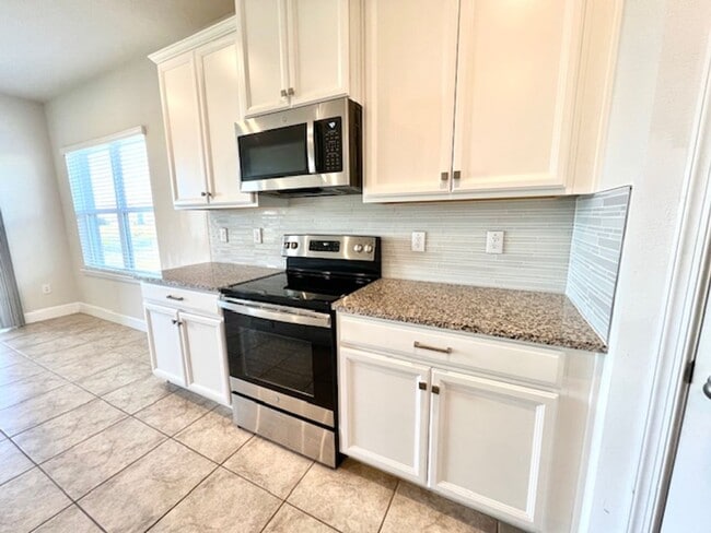 Photo - Open concept home offering four bedrooms, three baths, a two car garage and open lanai.