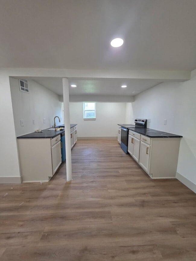 Photo - Studio Apartment with bathroom, kitchen & utility area on the lower level of property.