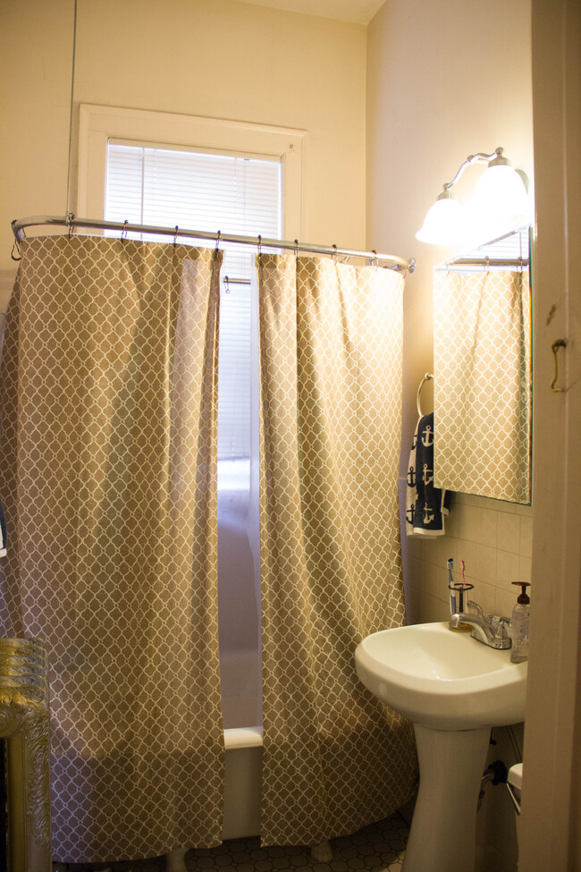 Antique claw foot tub for a luxurious deep soak, shower head with over sized enclosure for convenience - 2421 1st Ave S Apartment Unit 2419 #1