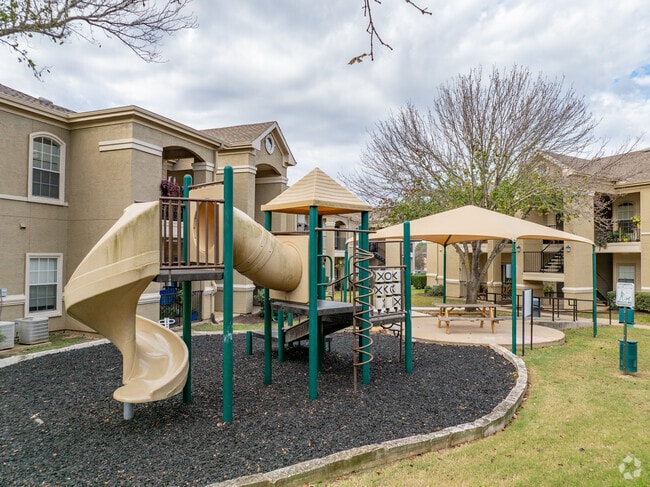 Playground & Grilling Area - The Lodge at Lost Pines Apartments
