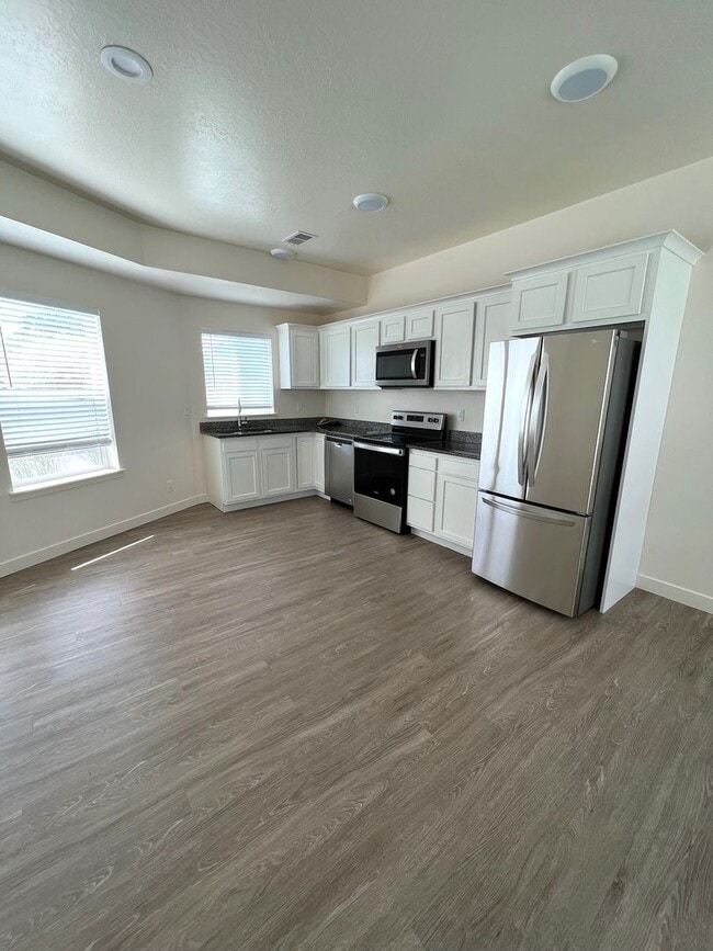 Photo - Hurry—Deposit Moves You In! | Modern 3-Bedroom Townhome with a 2-Car Garage & Private Balcony in ...