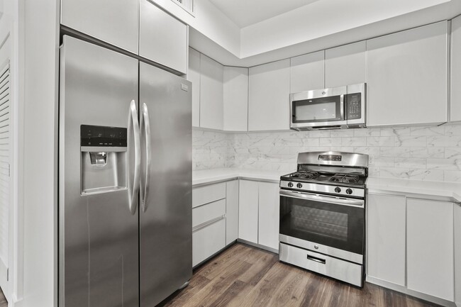 Kitchen with Stainless-Steel Refrigerator, Stove, and Microwave Oven