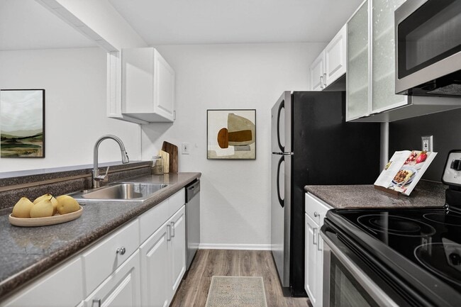 Elevate your lifestyle at The Woods at Ambler, an Eagle Rock Community. This modern kitchen features sleek appliances, ample storage, and a stylish design. Embrace comfort and convenience in your new home. Schedule a tour today! - The Woods at Ambler, an Eagle Rock Community
