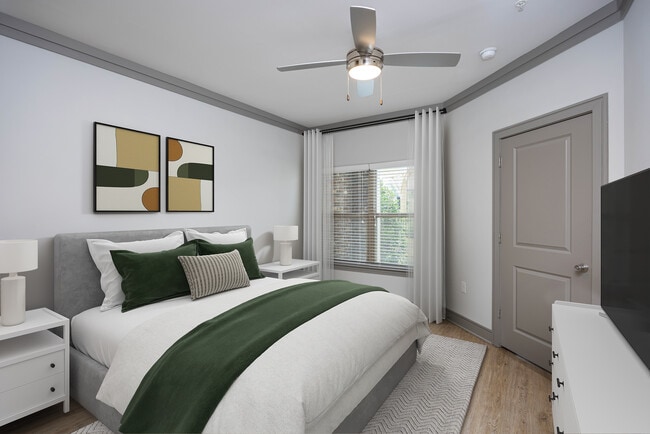 Bedroom with hard-surface vinyl plank flooring and ceiling fan