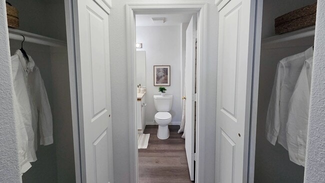 Enjoy the convenience of dual closets leading to a spacious bathroom, creating a private, organized suite designed to simplify your daily routine.