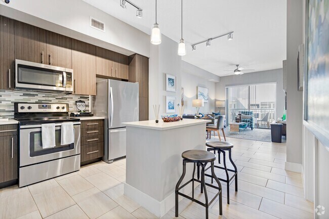 Kitchen and kitchen island within open concept apartment in Boca Raton. - Boca City Walk Rental