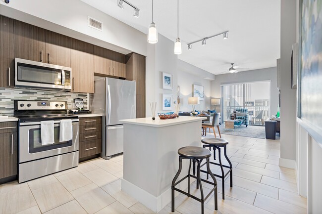 Kitchen and kitchen island within open concept apartment in Boca Raton. - Boca City Walk Apartments