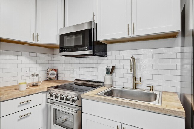Kitchen with Microwave and 2025 Appliances - 2802 Whitis Avenue