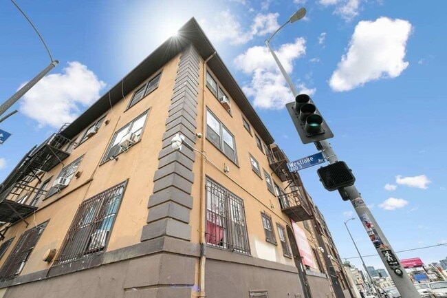 8th Street a tall building with a traffic light in front of it - Westland @ 8th Street