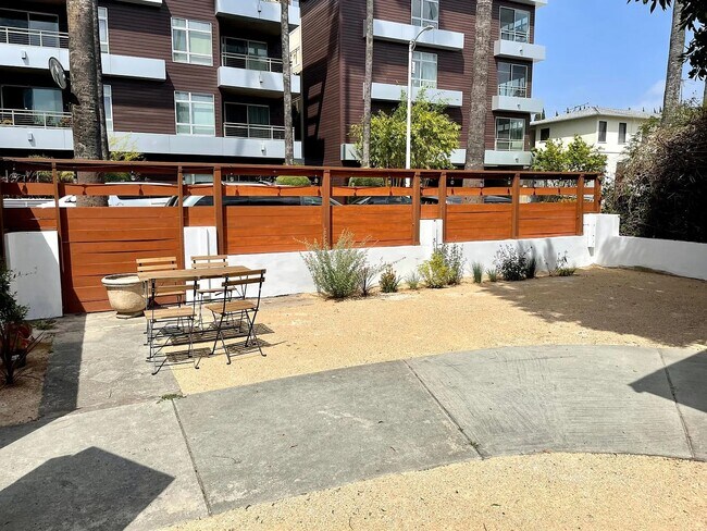 Private, fully fenced front yard with modern landscaping. Perfect for outdoor dining and relaxing. - 6000 Carlton Way