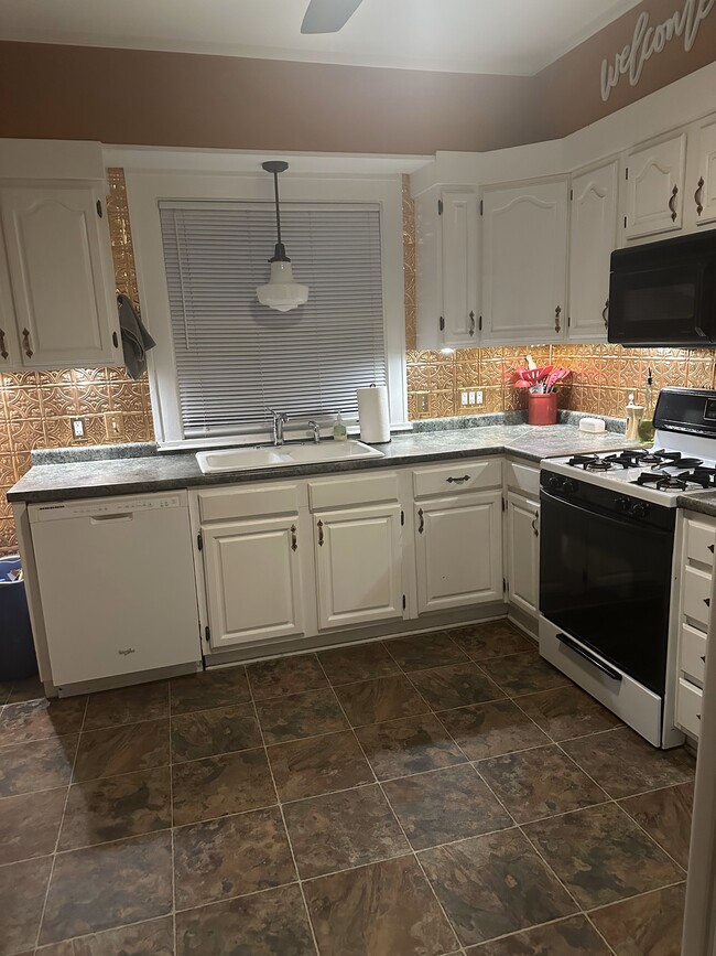 larger kitchen with copper backsplash - 1238 York St House