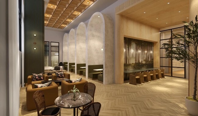 Coworking space with private work stations, coffee bar, and comfortable seating areas. - Modera Nations