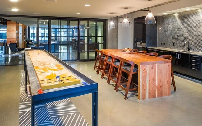 Play a round of shuffleboard, then sit down at the long table alongside.