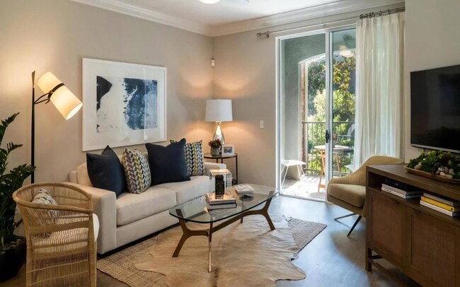 Spacious Living Room with Sliding Doors and Wood-Style Flooring - Amerige Pointe