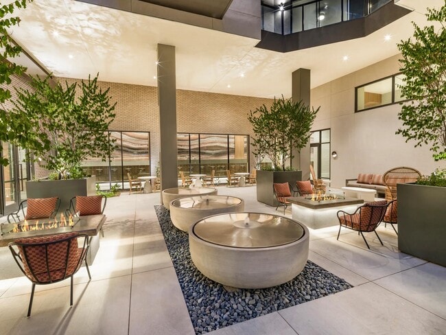 Relax in the serene courtyard with tranquil water features, cozy fire pits, and comfortable seating among lush greenery—ideal for quiet evenings or casual conversations.