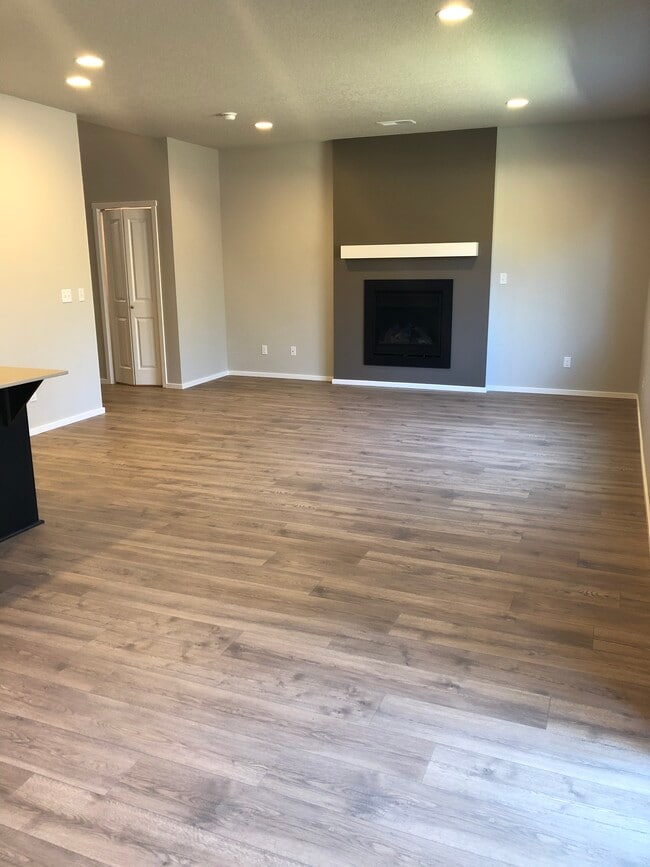 Open concept living room with fireplace - 20556 SE Evian Ave
