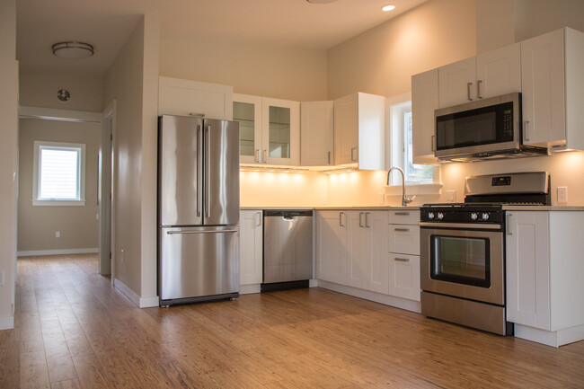 Kitchen with under-cabinet lighting, perfect for entertaining. - 5239 NE Mason St House